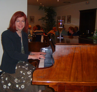 Diana with a  rather nice grand  piano in a Prague hotel